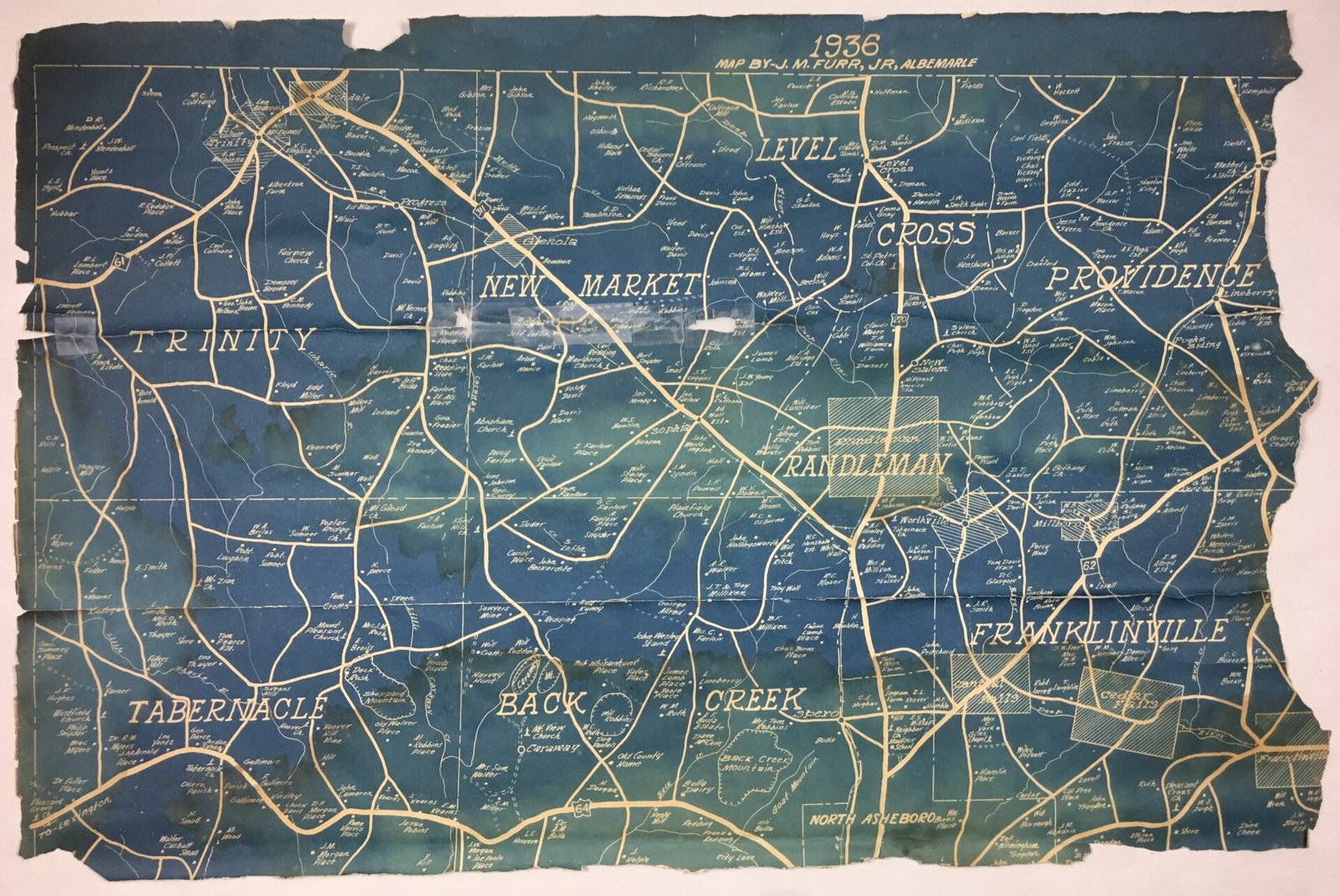 Damaged blueprint that is has been folded, creased and torn.