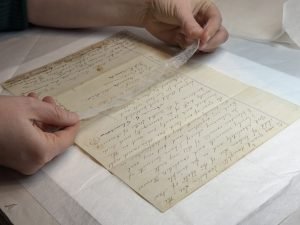 Applying a Japanese tissue mend to a document.